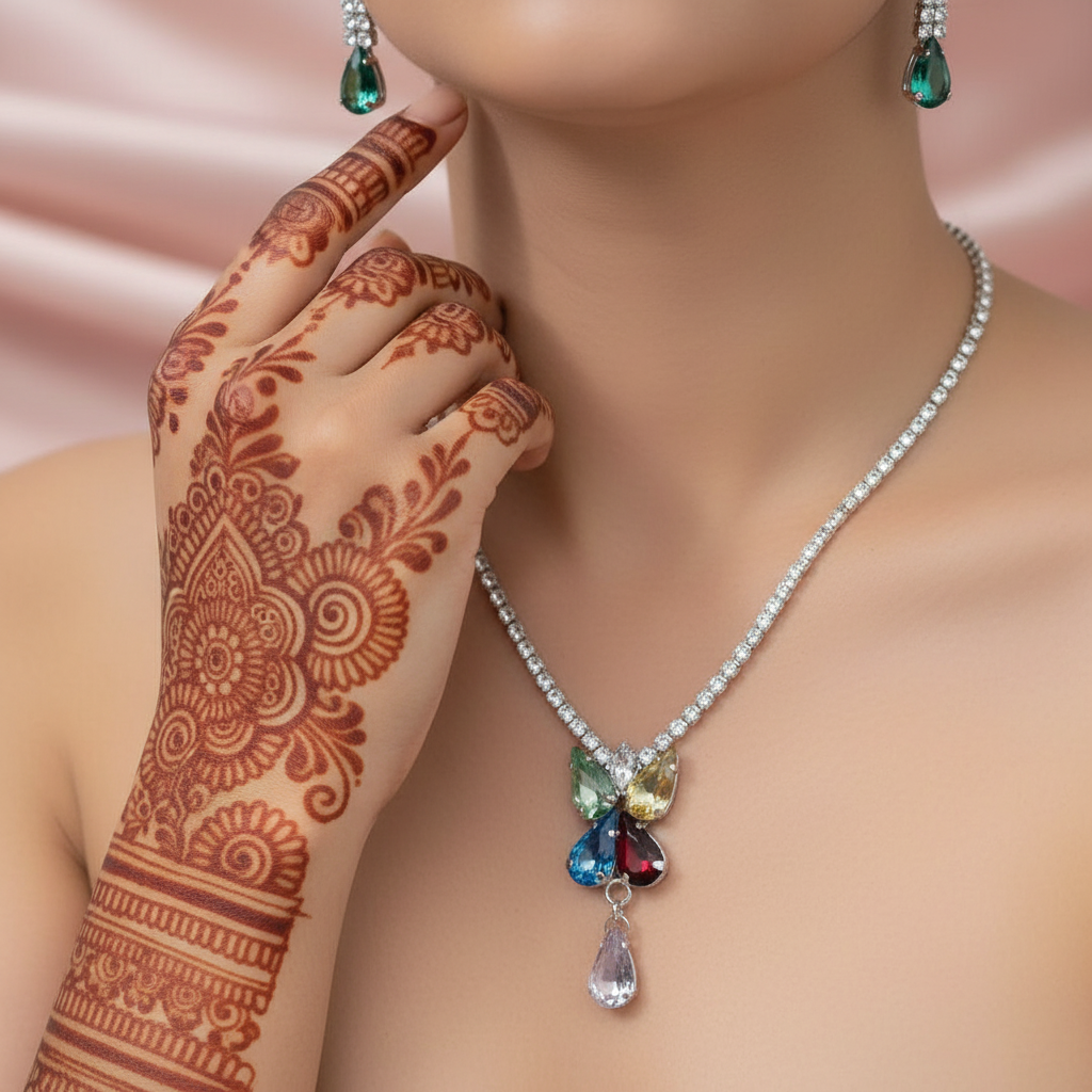 necklace with a multicolored, floral-inspired pendant and a single teardrop-shaped charm.