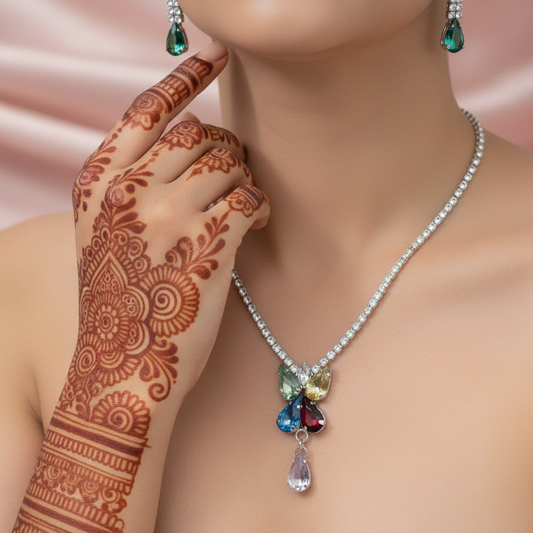 necklace with a multicolored, floral-inspired pendant and a single teardrop-shaped charm.