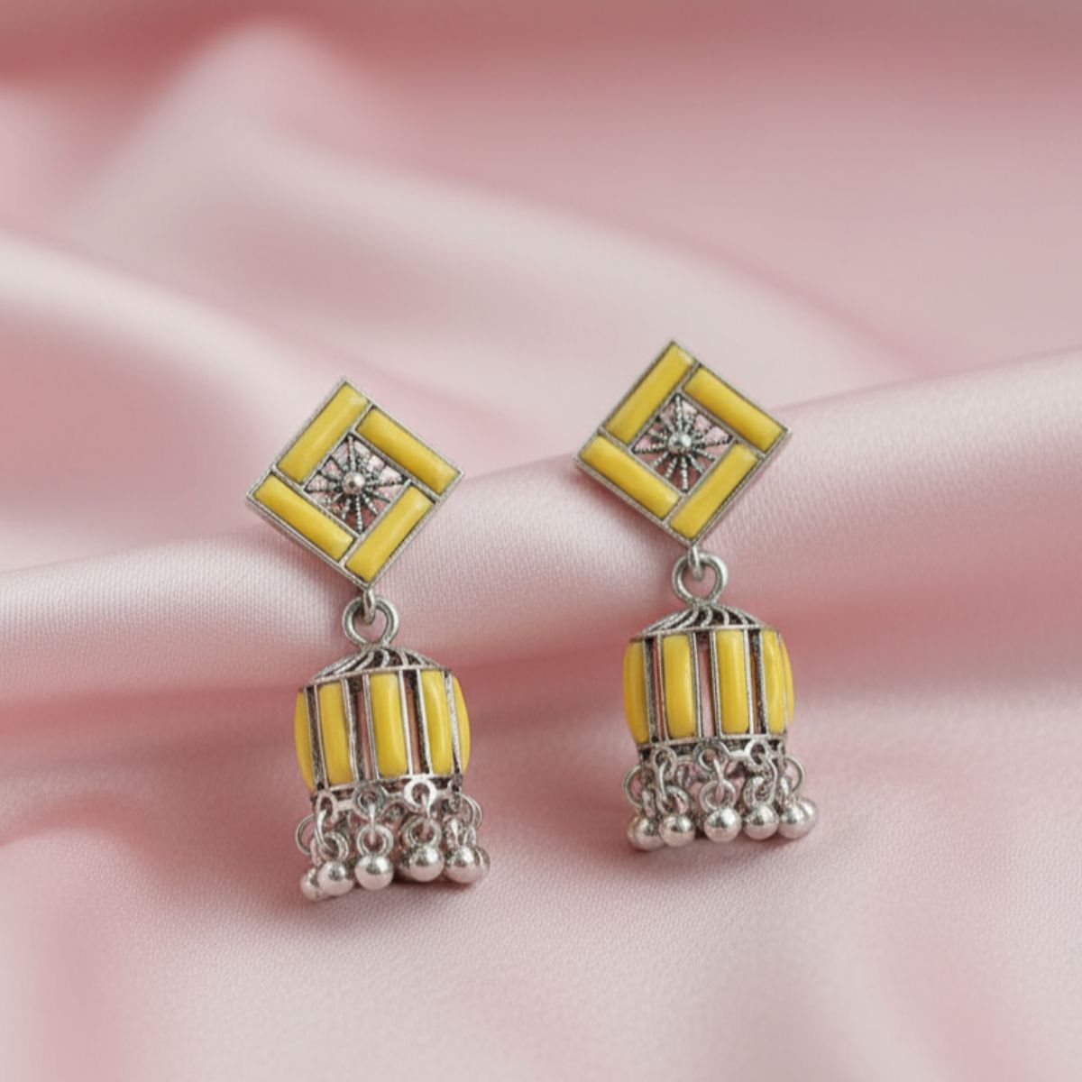 yellow and silver-toned jhumka earrings