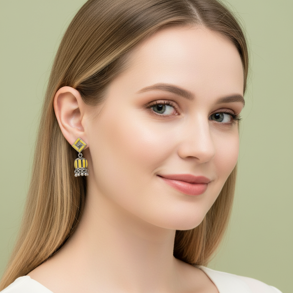 yellow and silver-toned jhumka earrings