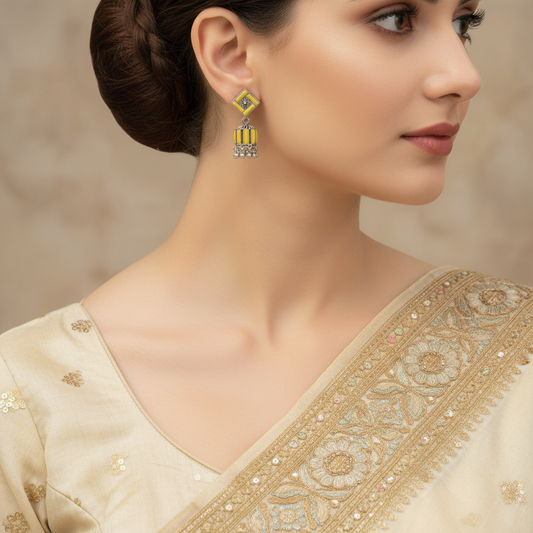 yellow and silver-toned jhumka earrings